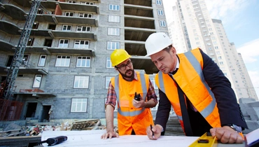 contractors reviewing construction plans and blueprints on job site in los angeles Premier Contractor LA